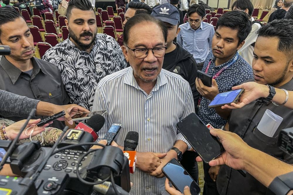 Opposition Leader Datuk Seri Anwar Ibrahim speaks to the media during the Town Hall session with youths at Universiti Malaya alumni centre September 11, 2022. — Picture by Hari Anggara 