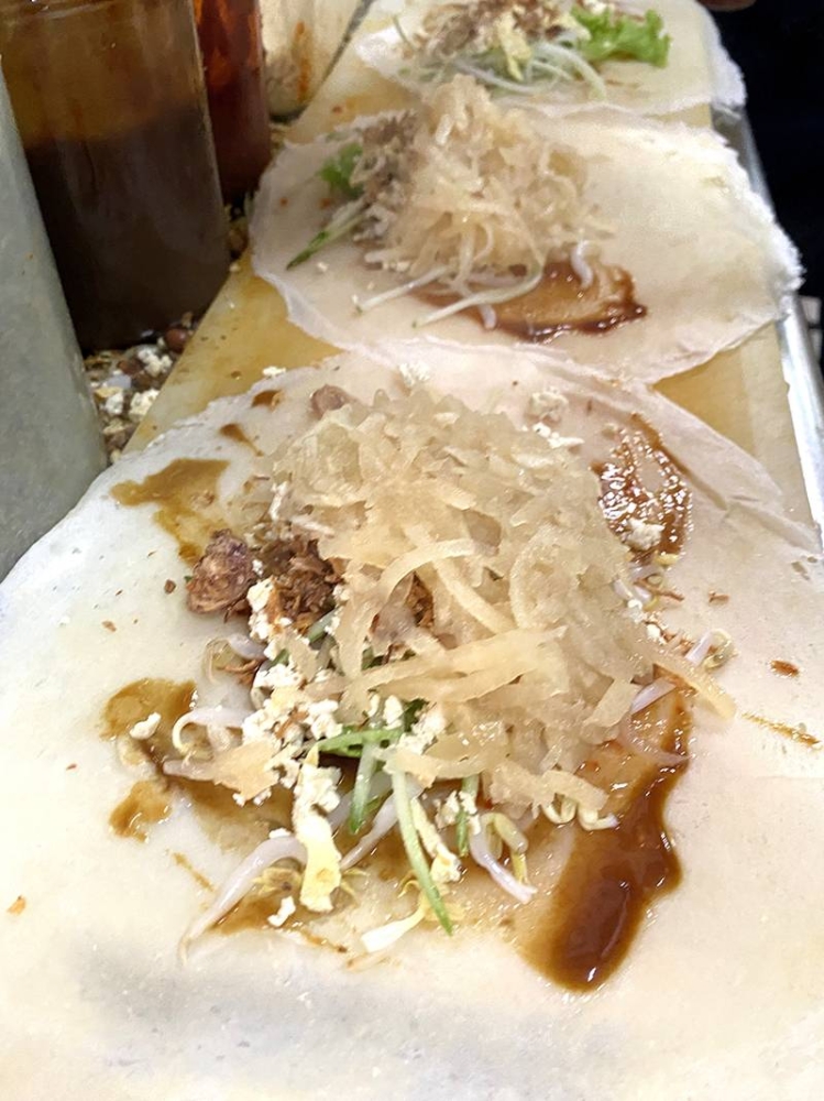 The ingredients are added in layers before rolling.