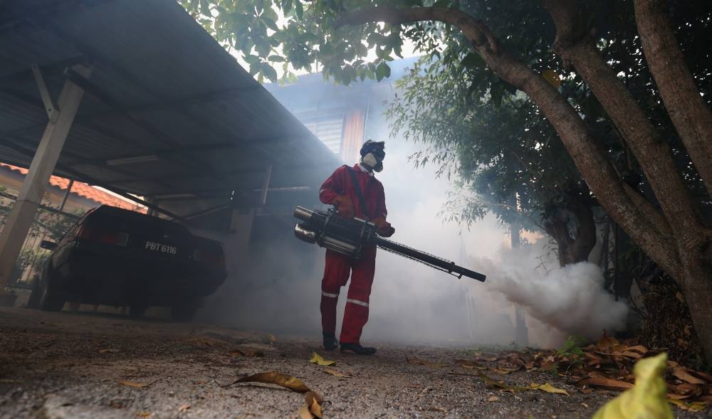 A worker from the Penang State Health Department fogs the common area of a public housing estate at Kampung Sungai Gelugor in Penang March 27, 2018. — Picture by Sayuti Zainuddin
