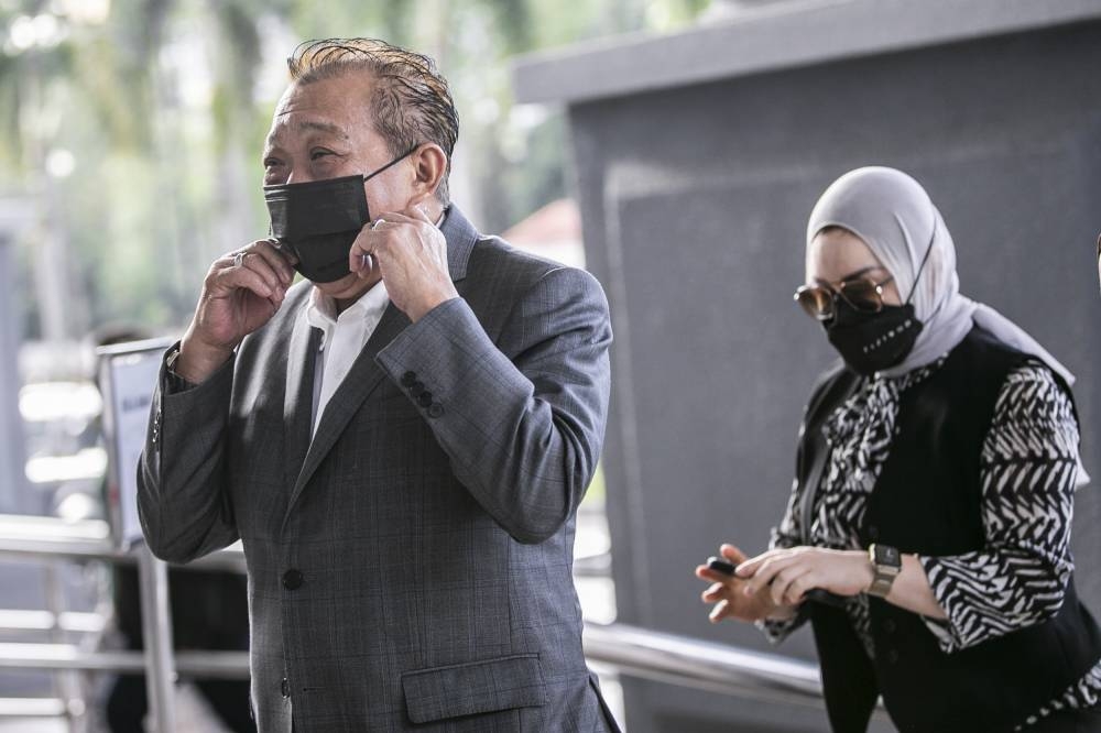Sabah Umno leader Datuk Seri Bung Moktar Radin (left) and his wife Datin Seri Zizie Izette Abdul Samad (right) arrived at the Kuala Lumpur Court Complex to defend themselves in the corruption trial September 26, 2022. — Picture by Hari Anggara