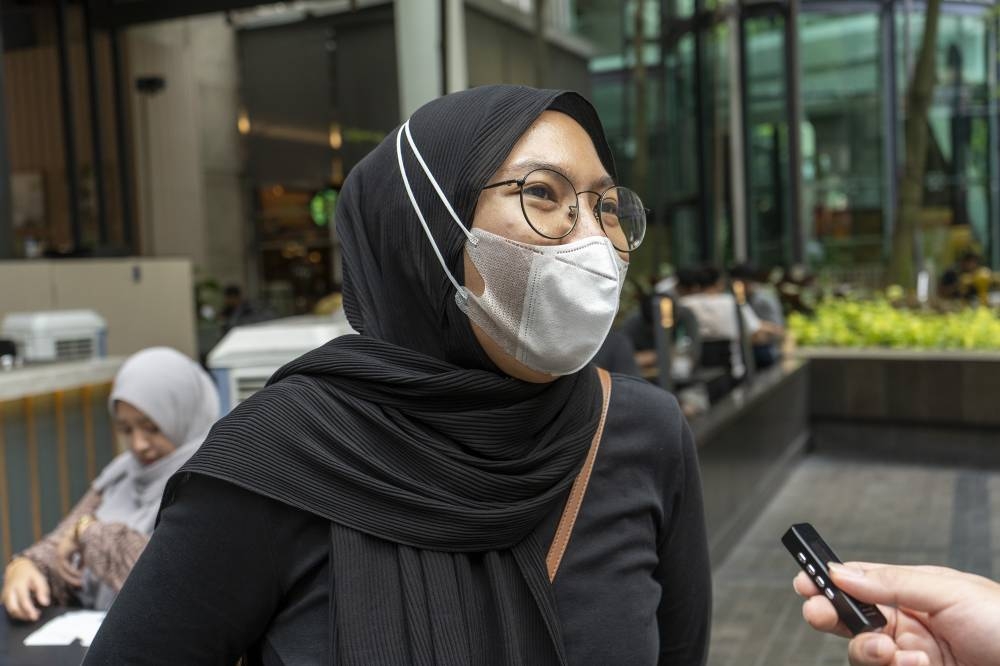 Jaja, 32, prefers to wear a face mask as a precaution. — Picture by Shafwan Zaidon