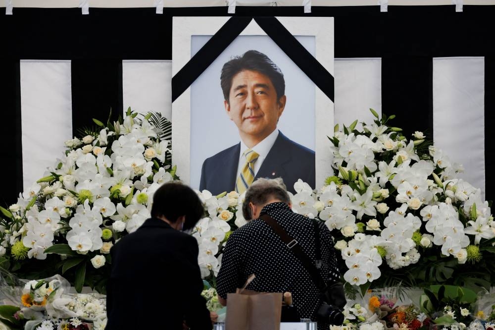 Mourners offer flowers at the altar outside Nippon Budokan Hall which will host a state funeral for former Prime Minister Shinzo Abe in Tokyo September 27, 2022. — Reuters pic