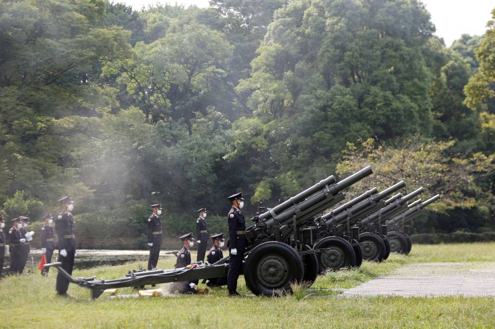 Japanese Ground Self-Defence Force personnel fire cannons at the Budokan grounds for the State Funeral of former Prime Minister Shinzo Abe in Tokyo September 27, 2022. — Pool pic via Reuters