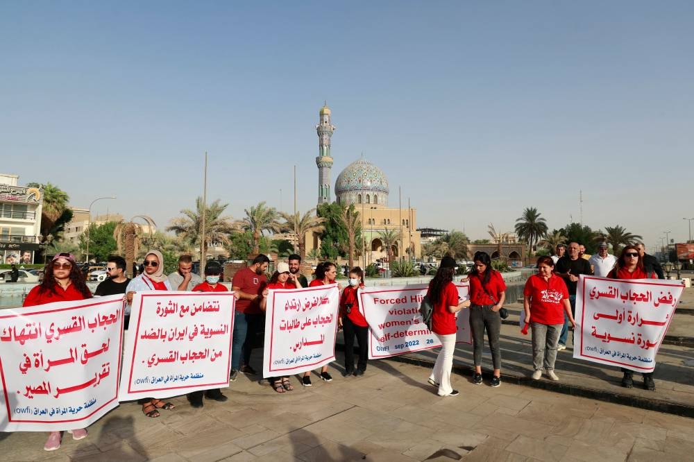 Iraqi women protest at al-Fardoos square in Baghdad on September 26, 2022 following a call by an Iraqi feminist NGO, in solidarity with Iranian women after the death of Mahsa Amini and against imposing wearing a headscarf on women. — AFP pic