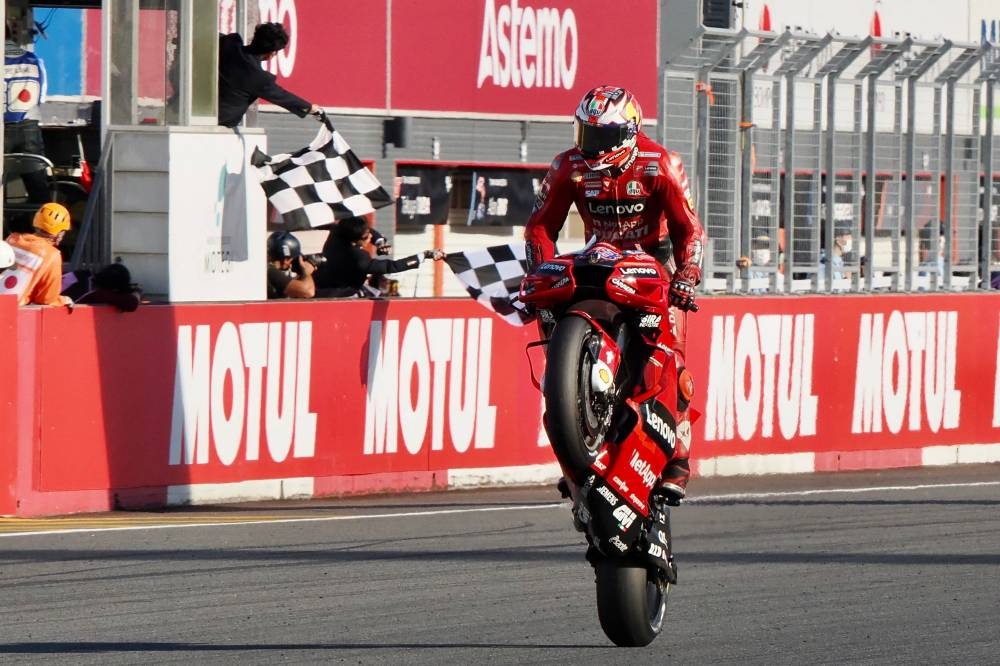 Ducati Lenovo team rider Jack Miller of Australia receives the chequered flag to win the MotoGP class race of the Japanese Grand Prix in Motegi, Tochigi prefecture, September 25, 2022. — AFP 