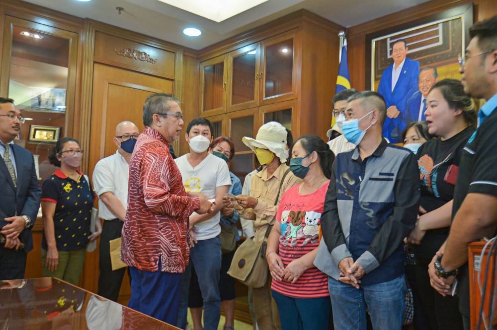 Minister in the Prime Minister’s Department (Special Functions), Dr Abdul Latiff Ahmad speaks to the victim’s families after a press conference on job scams abroad at Menara Usahawan in Putrajaya, September 20, 2022. — Picture by Shafwan Zaidon