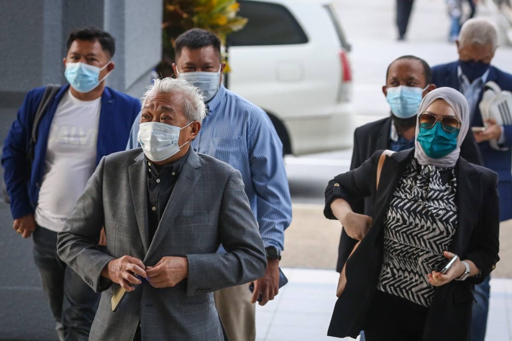 Datuk Seri Bung Moktar Radin and Datin Seri Zizie Izette Abdul Samad (right) arrive at the Kuala Lumpur High Court Complex January 26, 2022. — Picture by Yusof Mat Isa