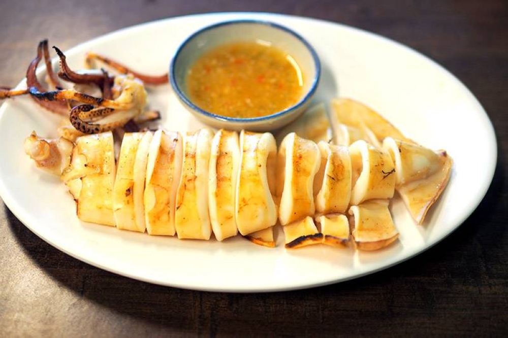 There's BBQ seafood items like this squid served with a tangy, spicy chilli dip.