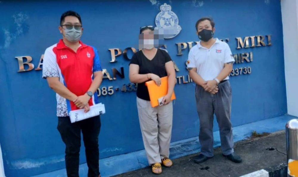 Yang is flanked by Hee (left) and DAP Miri member Alan Sia at the Central police station after following up on the case. — Borneo Post pic