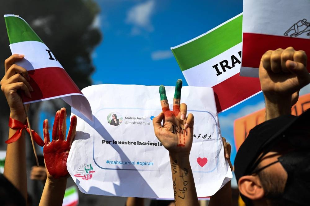 People stage a protest on October 1, 2022 in Rome, following the death of Kurdish woman Mahsa Amini in Iran. ― AFP pic