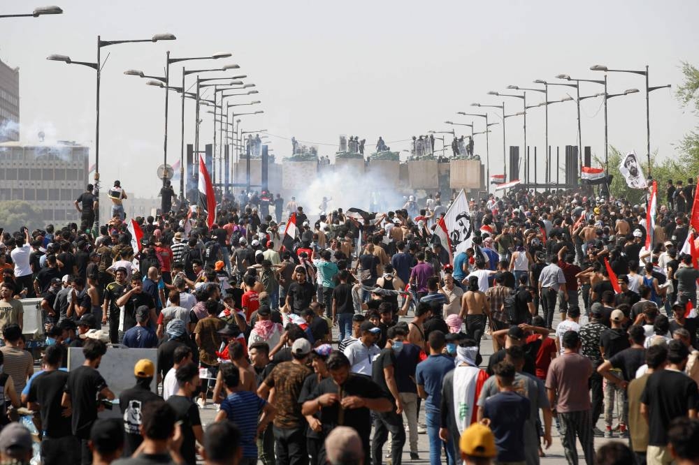 Iraqi security forces fire tear-gas at anti-government demonstrators during a protest on the Jumhuriya (Republic) bridge leading to the capital Baghdad’s high-security Green Zone on October 1, 2022. ― AFP pic