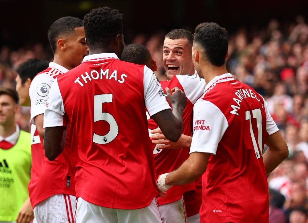 Arsenal’s Granit Xhaka celebrates scoring their third goal with teammates during their match against Tottenham Hotspur at the Emirates Stadium in London, October 1, 2022. ― Reuters pic