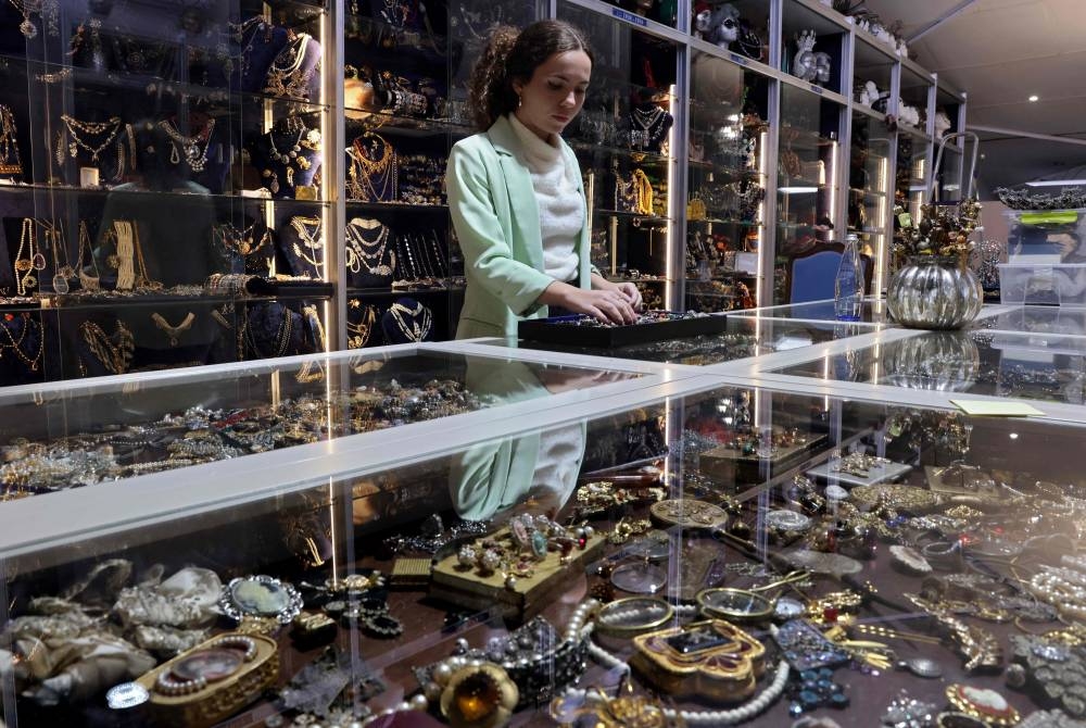 An employee of Peris Costumes company tidies up jewellery and accessories from different periods to hire for the film industry, in Algete, northern Madrid, on September 26, 2022. — AFP pic