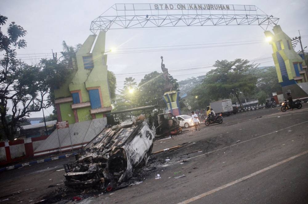 This picture shows a torched car outside Kanjuruhan stadium in Malang, East Java on October 2, 2022. At least 127 people were killed when angry fans invaded a football pitch after a match in Malang, East Java in Indonesia late on October 1, police said. — AFP pic