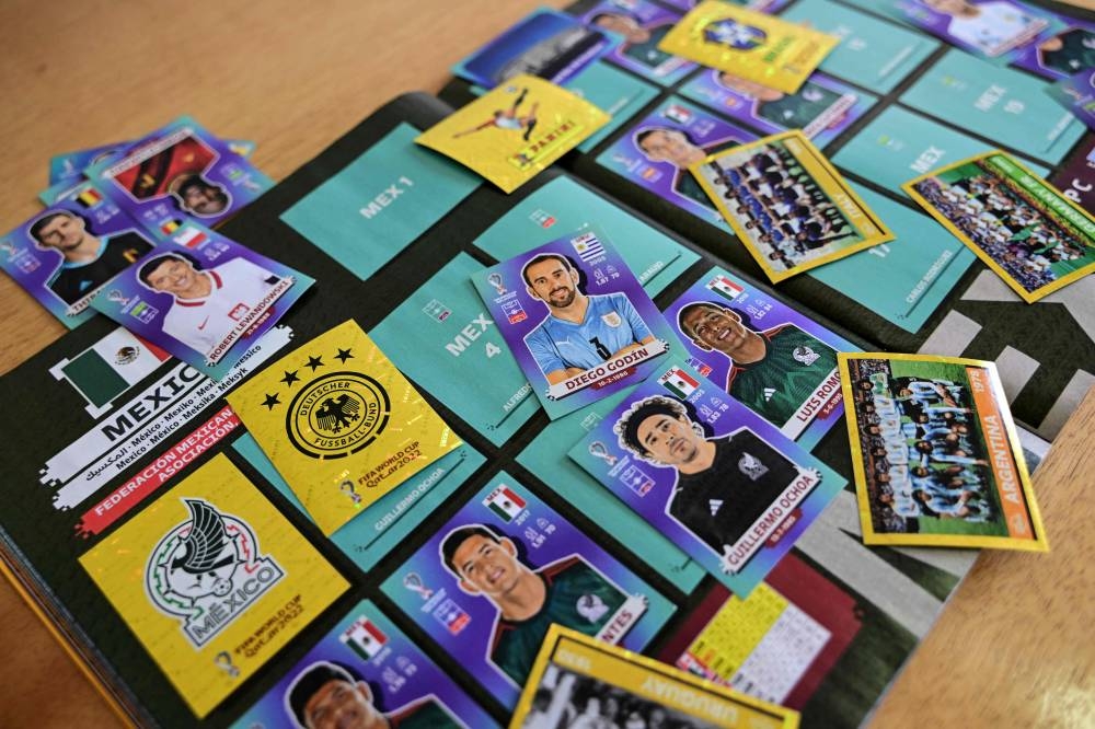 View of the Panini World Cup football album and stickers in Santiago, on September 23, 2022. — AFP pic