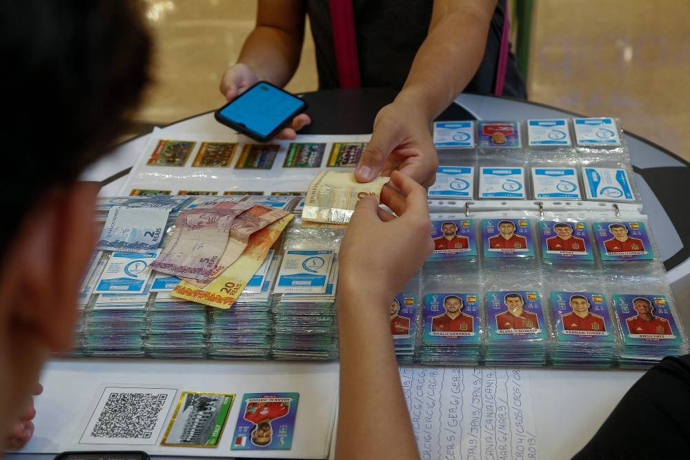 A child buys Panini World Cup football stickers at the Analia Franco shopping center in Sao Paulo, Brazil, on September 23, 2022. — AFP pic
