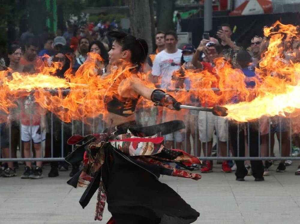 A performer for a roving act called Kaguzuchi entertaining a crowd at the Marina Bay circuit park of the Singapore Grand Prix on October 2, 2022. — TODAY pic