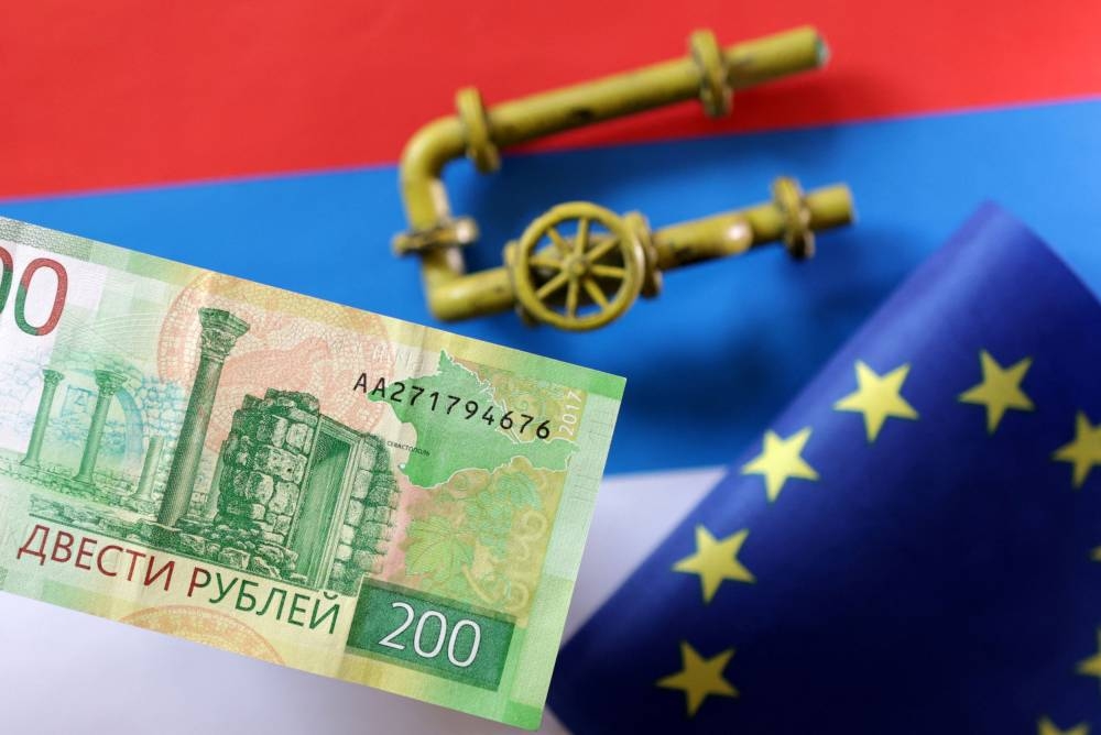 A model of a natural gas pipeline, a Rouble banknote and a torn European Union flag are placed on a Russian flag in this illustration taken September 7, 2022. — Reuters pic