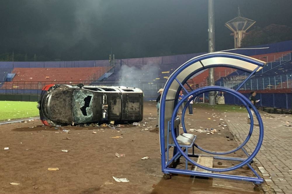 A damaged car is pictured following a riot after the league BRI Liga 1 football match between Arema vs Persebaya at Kanjuruhan Stadium, Malang, East Java province, Indonesia, October 2, 2022, in this photo taken by Antara Foto. — Antara Foto/Ari Bowo Sucipto/Reuters pic