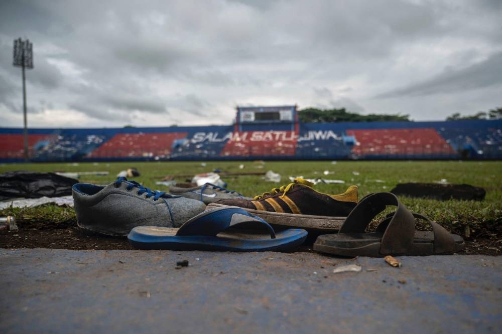 Discarded shoes sit by the pitch at Kanjuruhan stadium days after a deadly stampede following a football match in Malang, East Java, October 3, 2022. — AFP pic 