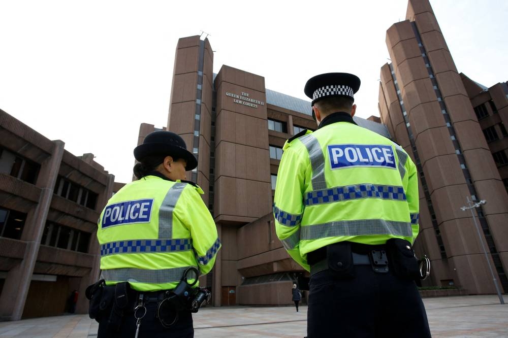 Police officers stand guard outside Liverpool Crown Court, where Thomas Cashman, who has been charged with the murder of nine-year-old Olivia Pratt-Korbel, appears in Liverpool, Britain October 3, 2022. — Reuters pic