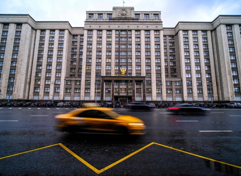 Cars pass in front of the State Duma building, Russia’s lower house of parliament, where lawmakers are to consider treaties formally annexing four regions of Ukraine Russian troops occupy: Lugansk, Donetsk, Kherson and Zaporizhzhia, in Moscow, October 3, 2022. — AFP pic