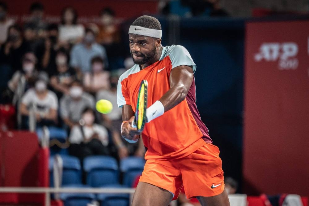 Frances Tiafoe of the US hits a return against Yasutaka Uchiyama of Japan during their men’s singles match at the Japan Open tennis tournament in Tokyo, October 3, 2022. — AFP pic  