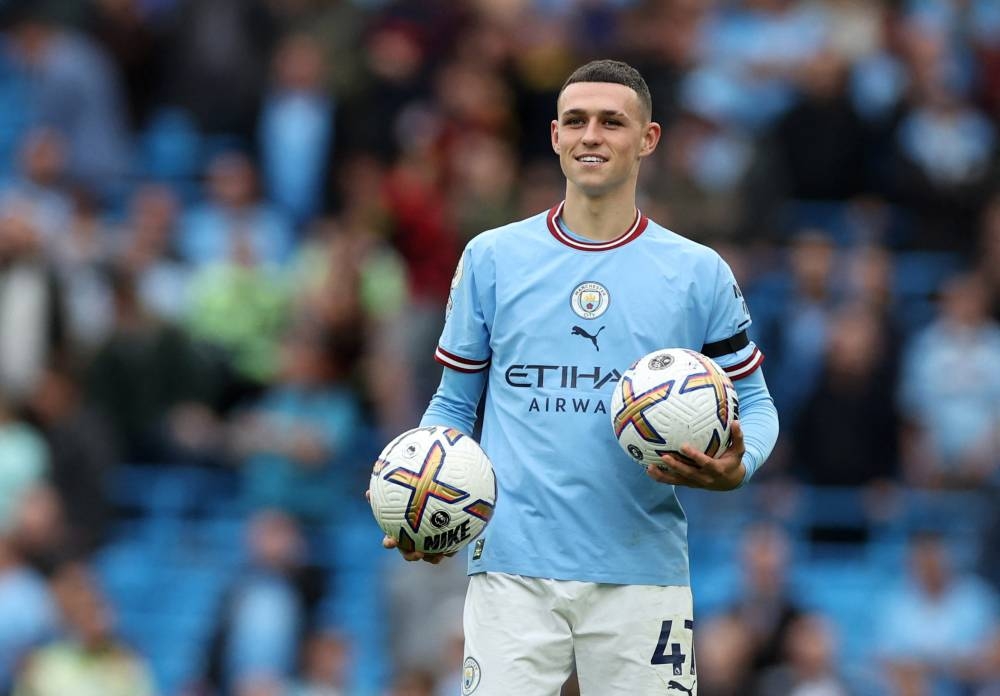 Manchester City's Phil Foden celebrates with the match ball after the match against Manchester United at the Etihad Stadium, Manchester October 2, 2022. — Reuters pic