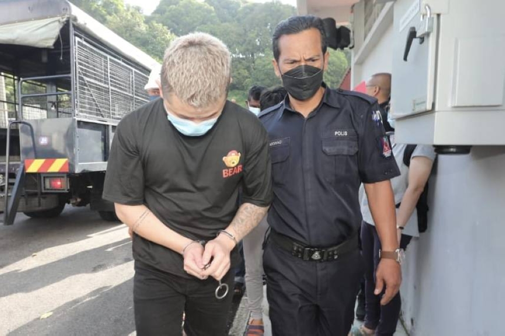 The 28-year-old male suspect arrives at the Magistrate's Court in Johor Baru October 3, 2022. — Picture by Ben Tan
