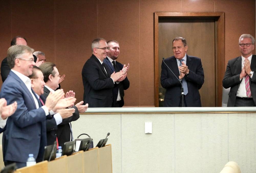 Officials, including Russian Foreign Minister Sergei Lavrov and members of the Russian State Duma, the lower house of parliament, applaud during a session to approve laws on annexing Ukraine's Donetsk, Kherson, Luhansk and Zaporizhzhia regions into Russia, in Moscow, Russia October 3, 2022. — Russian State Duma/Handout via Reuters 