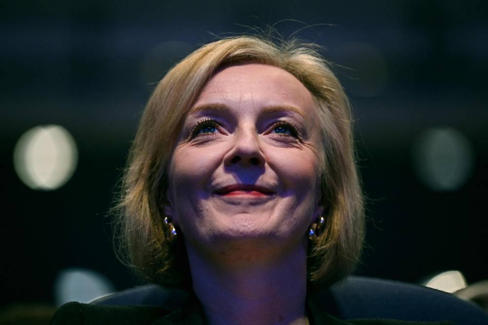 Liz Truss said she did not intend to fire Mordaunt, and denied that she had lost control of her cabinet after putting on a show of unity with Kwarteng on a visit to a construction site in Birmingham. — AFP pic