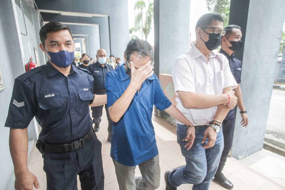Three men were fined RM175,950 each by the Session Court in Ipoh for possessing a total of 17,595 units of fake branded shoes. ― Picture by Farhan Najib