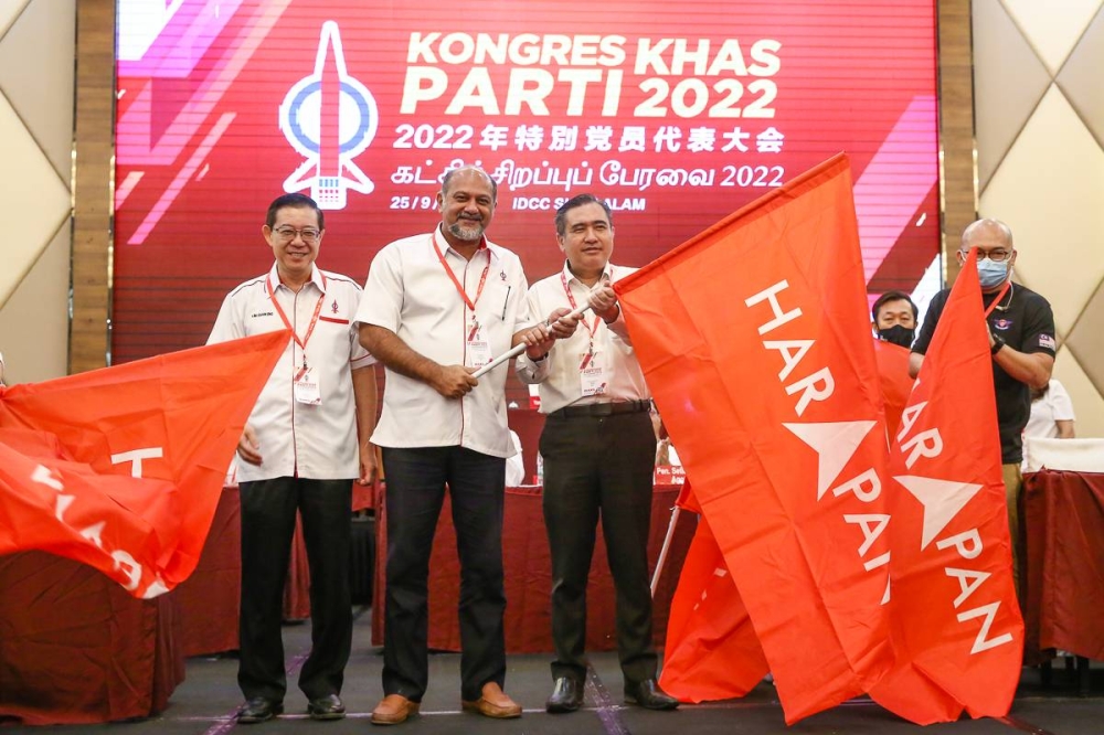 DAP leaders hold flags with the Pakatan Harapan logo at the Ideal Convention Centre in Shah Alam on September 25, 2022. — Picture by Yusof Mat Isa
