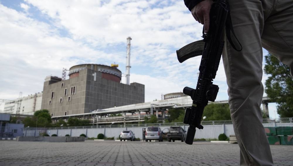 This file photo taken on September 11, 2022 shows a security person standing in front of the Zaporizhzhia Nuclear Power Plant in Enerhodar (Energodar), Zaporizhzhia Oblast, amid the ongoing Russian military action in Ukraine. — Stringer/AFP pic