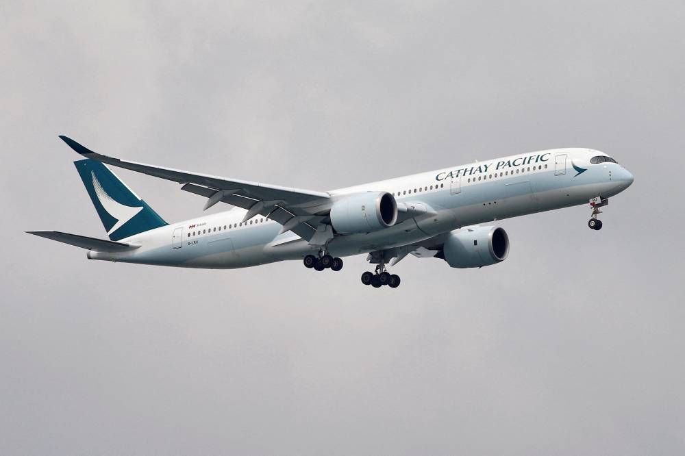 A Cathay Pacific Airways Airbus A350-900 airplane approaches to land at Changi International Airport in Singapore June 10, 2018. — Reuters pic