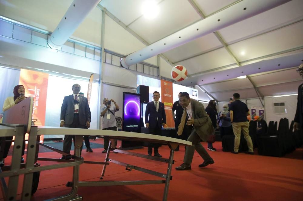 Youth and Sports Minister Datuk Seri Ahmad Faizal Azumu shows off his Teqball skills while visiting the Kuala Lumpur Sports Industry Expo, October 6, 2022. — Bernama pic 
