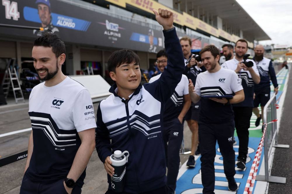 AlphaTauri’s Yuki Tsunoda with team members ahead of the Japanese Grand Prix at the Suzuka Circuit, Suzuka, Japan, October 6, 2022. — Reuters pic 