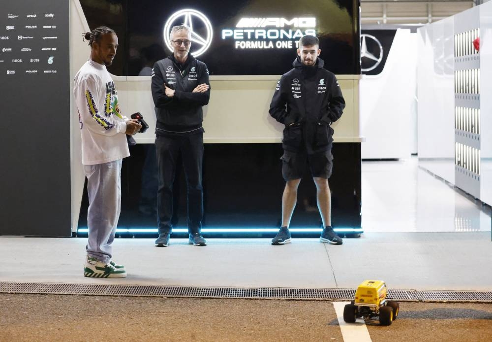 Mercedes’ Lewis Hamilton plays with a remote controlled car ahead of the Japanese Grand Prix at Suzuka Circuit, Suzuka, Japan, October 6, 2022. — Reuters pic 