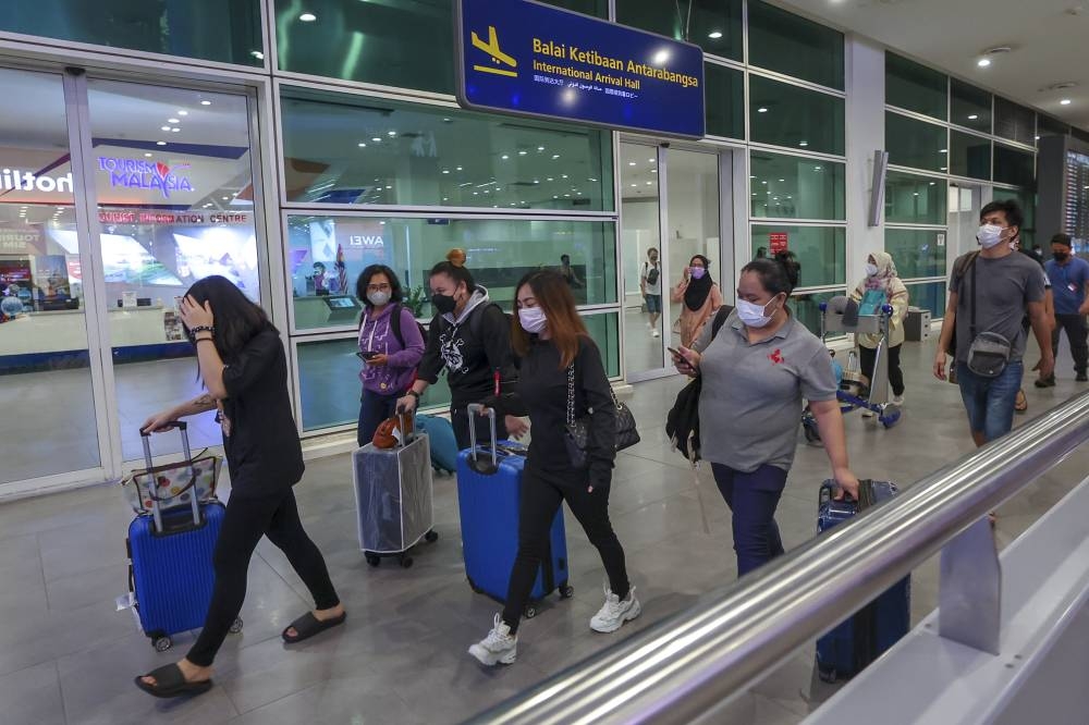 Malaysians who were victims of a fraudulent job offer syndicate in Cambodia returned home safely at Kuala Lumpur International Airport 2, October 6, 2022. — Bernama pic 