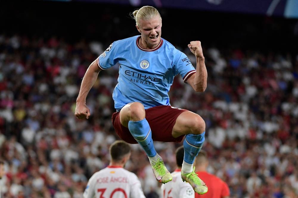 Manchester City striker Erling Haaland celebrates after scoring his team’s third goal during the against Sevilla FC, at the Ramon Sanchez Pizjuan stadium in Seville September 6, 2022. — AFP pic