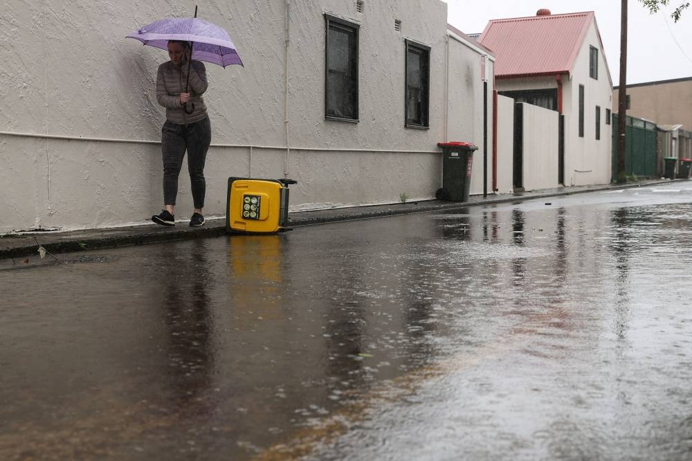 A pedestrian walks along a flooded street as heavy rains affect Sydney, Australia, October 6, 2022. — Reuters pic