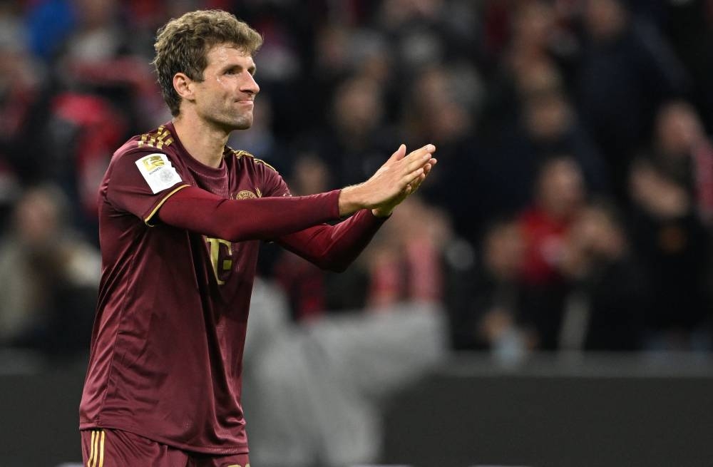 Bayern Munich's German forward Thomas Mueller apologizes after scoring his team's fourth goal during the German first division Bundesliga football match between FC Bayern Munich and Bayer 04 Leverkusen in Munich on September 30, 2022. — AFP pic