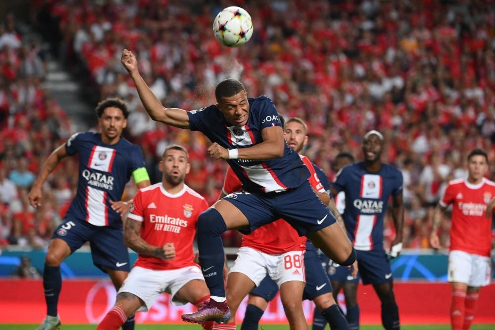 Paris Saint-Germain forward Kylian Mbappe heads the ball during the Uefa Champions League 1st round day 3 group H football match between SL Benfica and Paris Saint-Germain, at the Luz stadium in Lisbon, October 5, 2022. — AFP pic 