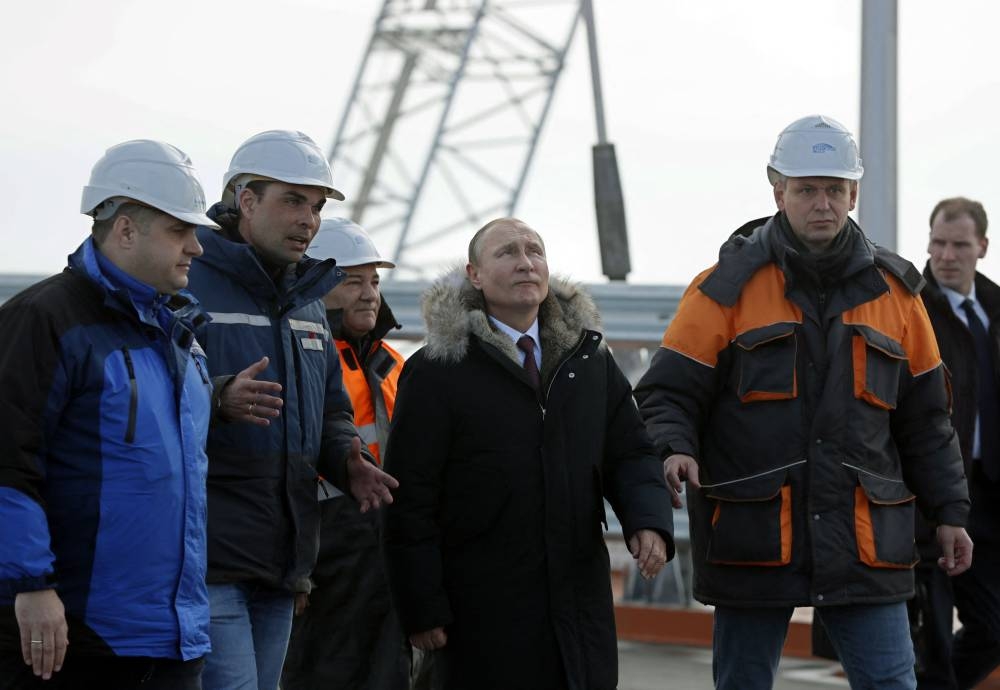 In this file photo taken on March 14, 2018 Russian President Vladimir Putin (centre) inspects the road section of the road-and-rail Crimean Bridge over the Kerch Strait. — AFP pic