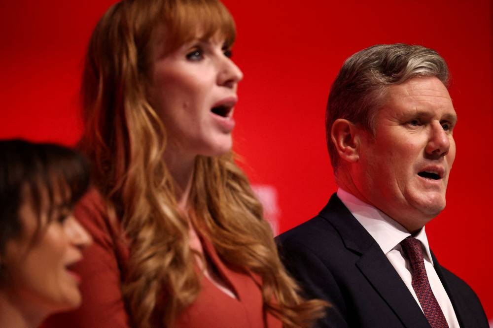 File photo of British Labour Party leader Keir Starmer and deputy leader of the Labour Party Angela Rayner sing during Britain’s Labour Party annual conference in Liverpool, Britain, September 28, 2022. — Reuters pic