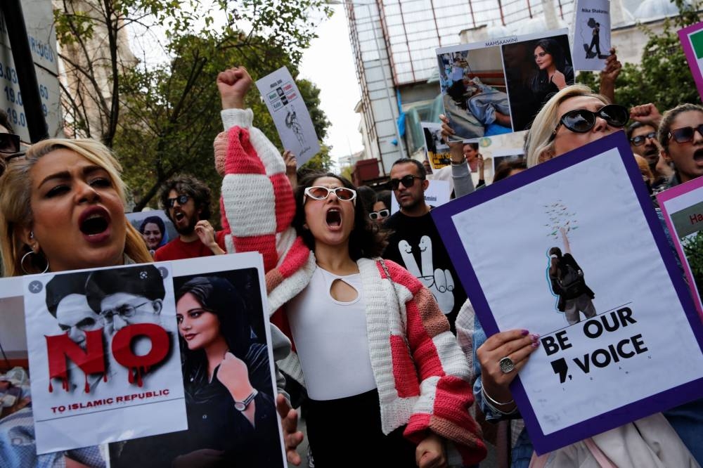 Demonstrators shout slogans during a protest in support of Iranian women and against the death of Mahsa Amini, near the Iranian consulate in Istanbul, Turkey October 7, 2022. — Reuters pic