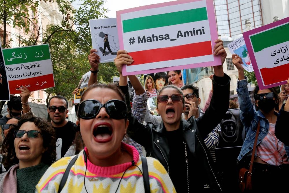 Demonstrators shout slogans during a protest in support of Iranian women and against the death of Mahsa Amini, near the Iranian consulate in Istanbul, Turkey October 7, 2022. — Reuters pic