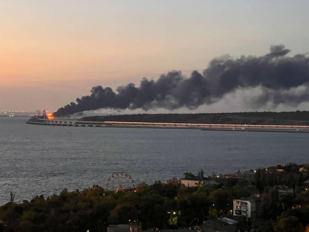 A view shows a fire on the Kerch bridge at sunrise in the Kerch Strait, Crimea, October 8, 2022. — Reuters pic