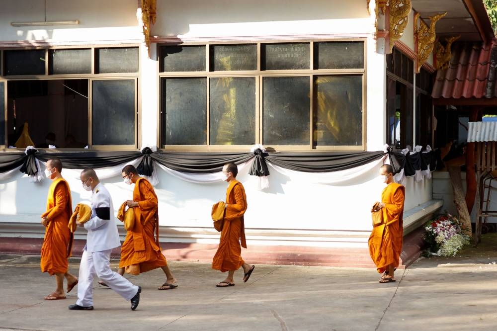 Monks leave the funeral at Wat Rat Samakee temple, following a mass shooting in the town of Uthai Sawan, Nong Bua Lam Phu province, Thailand, October 8, 2022. — Reuters pic