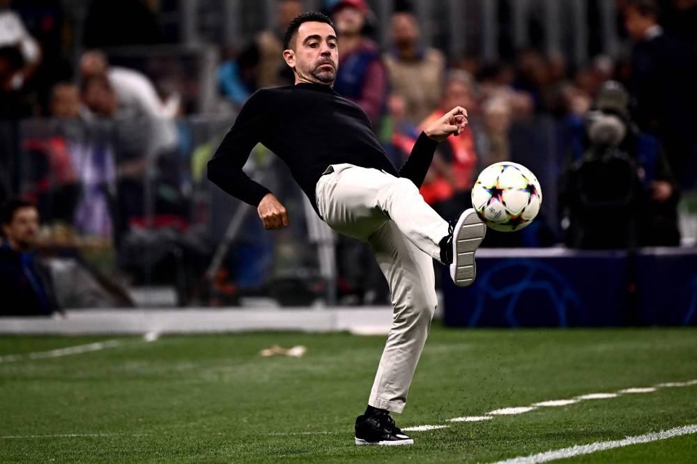 File photo of Barcelona’s Spanish coach Xavi Hernandez kicking the ball from the touchline during the UEFA Champions League Group C football match between Inter Milan and FC Barcelona on October 4, 2022 at the Giuseppe-Meazza (San Siro) stadium in Milan. — AFP pic